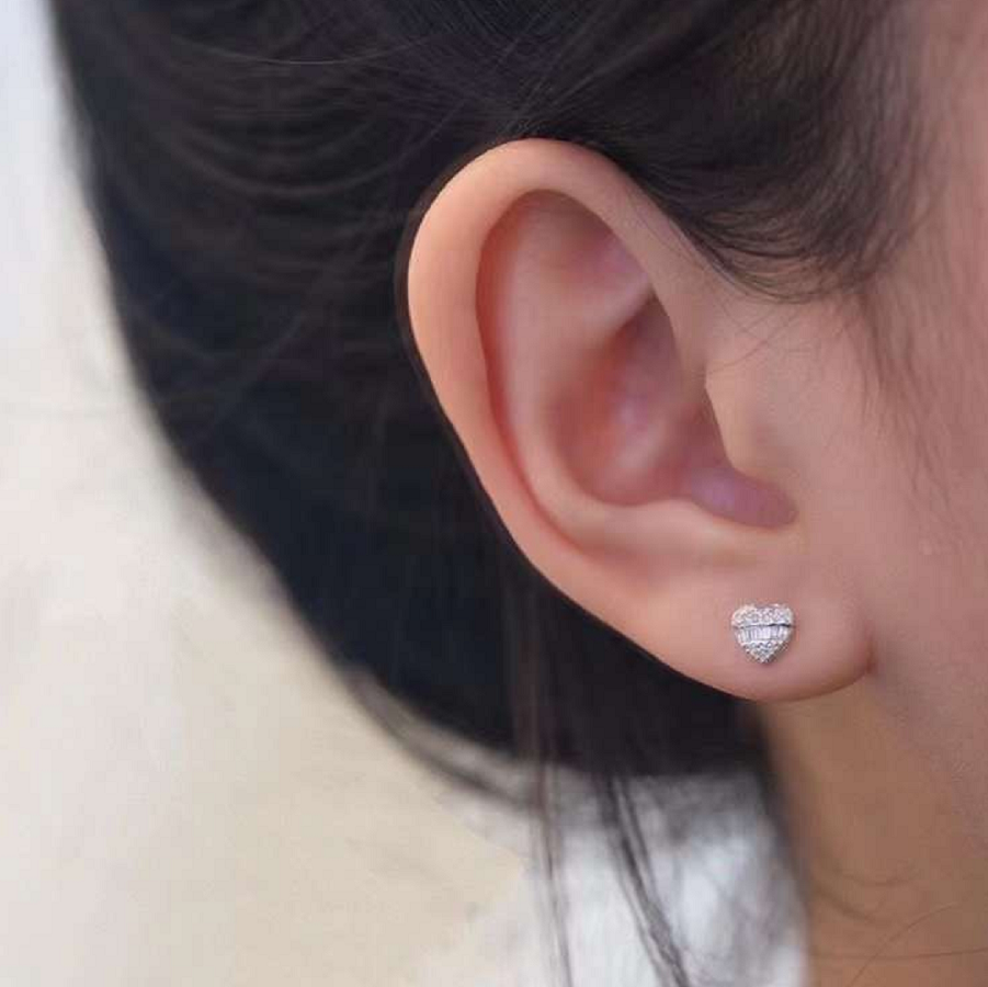 Heart diamond stud earring worn on ear