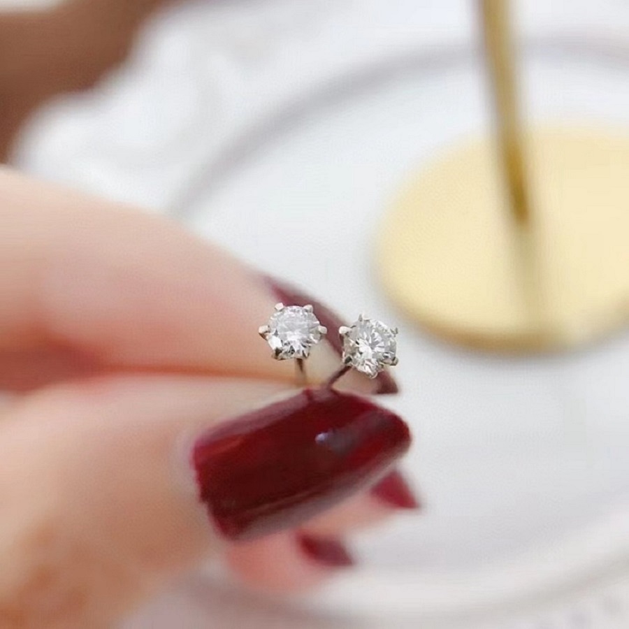 Classic diamond stud earring worn on ear